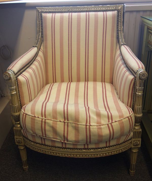 A pair of Louis XVI style cream and silver painted square back fauteuils, with bow seats on fluted supports, (2).