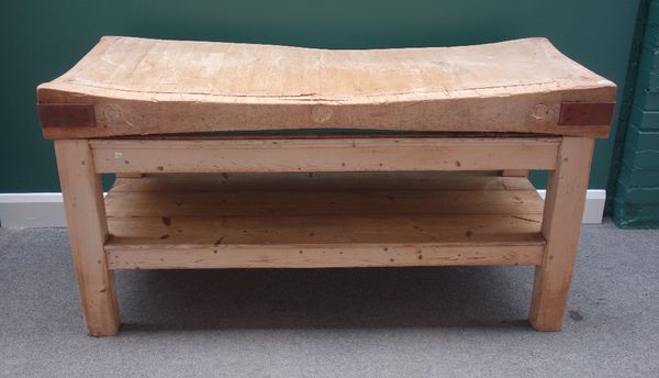 A large rectangular iron bound butcher's block, the beech top on a pine base, with four block supports, united by platform undertier, 155cm wide.