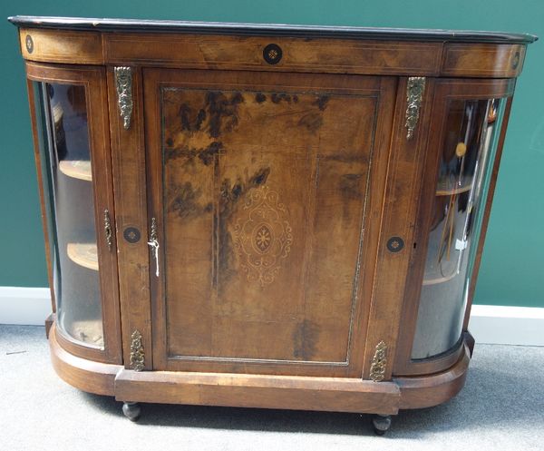 A Victorian marquetry inlaid, gilt metal mounted figured walnut credenza, the central panel door flanked by two rounded glazed cupboards, 136cm wide.