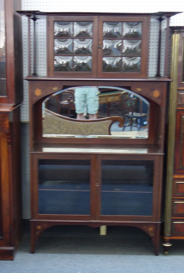 An Art Nouveau copper and brass inlaid mahogany side display cabinet, with two sets of glazed cupboard, divided by mirror back, 117cm wide x 186cm hig