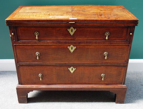 An 18th century and later walnut bachelor's chest, the foldover top above three long graduated drawers, on bracket feet, 92cm wide.