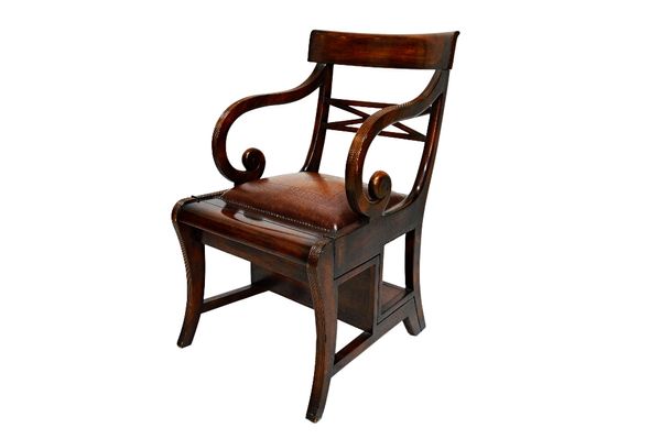 A Regency style mahogany metamorphic library armchair, on sabre supports.  Illustrated