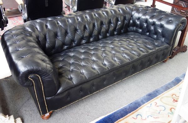 A Victorian later studded black leather upholstered button back Chesterfield sofa, on turned walnut supports, 198cm wide.