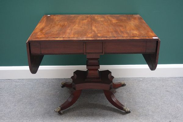 A George III rosewood banded mahogany sofa table, with pair of frieze drawers, on shaped square column and four downswept supports, 90cm wide.