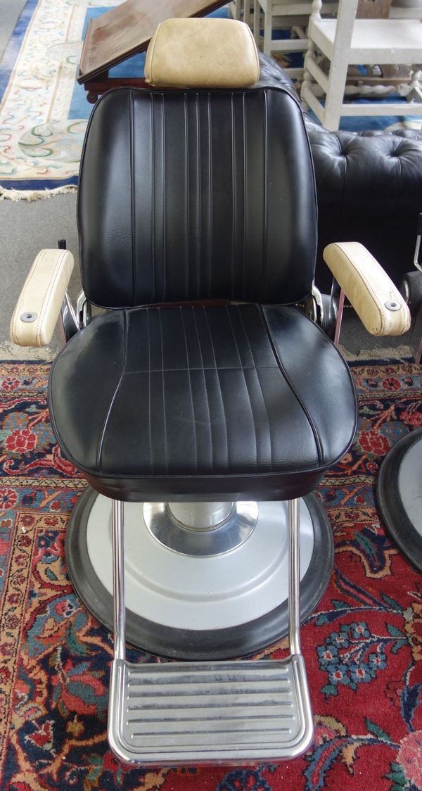 Takara Belmont Product of Japan; a mid 20th century cream and black leatherette upholstered barber's chair, with height adjustment column and angled b