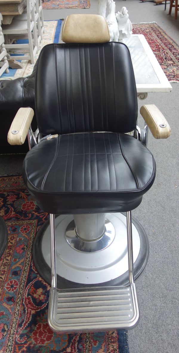 Takara Belmont Product of Japan; a mid 20th century cream and black leatherette upholstered barber's chair, with height adjustment column and angled b