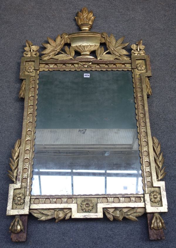 An 18th century French gilt framed wall mirror, with flaming urn crest about the laurel leaf carved frame, on claw and ball feet, 71cm wide x 134cm hi