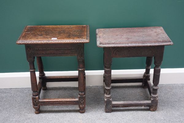 A 17th century carved oak joint stool, on turned supports, united by a perimeter stretcher, 46cm wide, together with another similar, 48cm wide, (2).