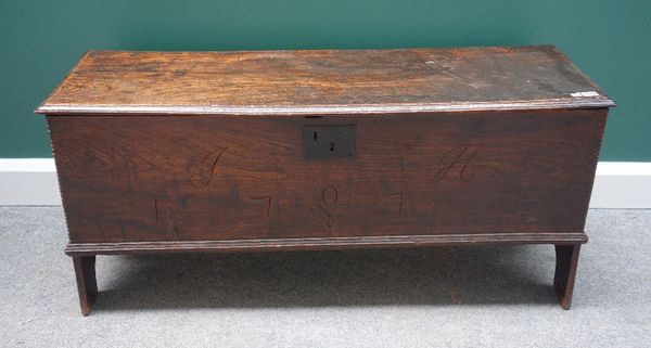 A 17th century oak five plank coffer, with chip work decoration, on slab end supports, 118cm wide.