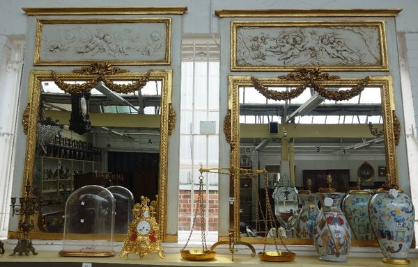 A pair of 18th century French style, grey painted parcel gilt wall mirrors, each with recumbent cherub moulded upper frieze, above rectangular mirror