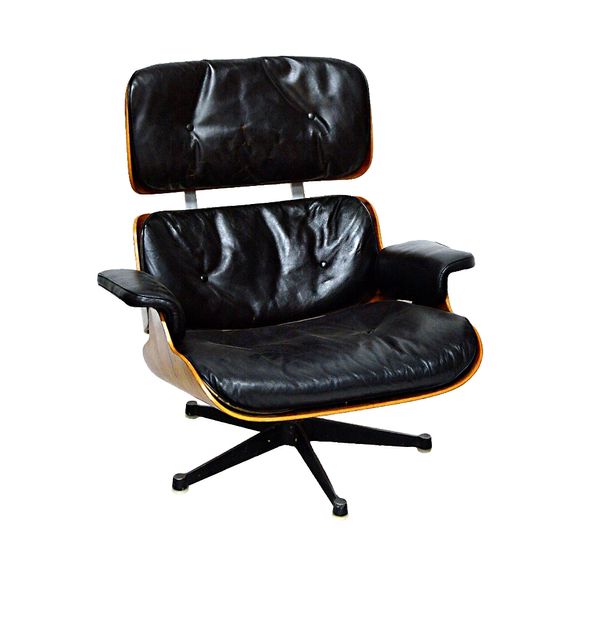 Charles Eames, a pair of laminated rosewood black leather upholstered easy armchairs, together with a footstool for Herman Miller-Zeeland- Michigan, M