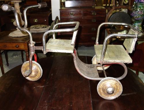 A child's twin seated vintage tricycle.