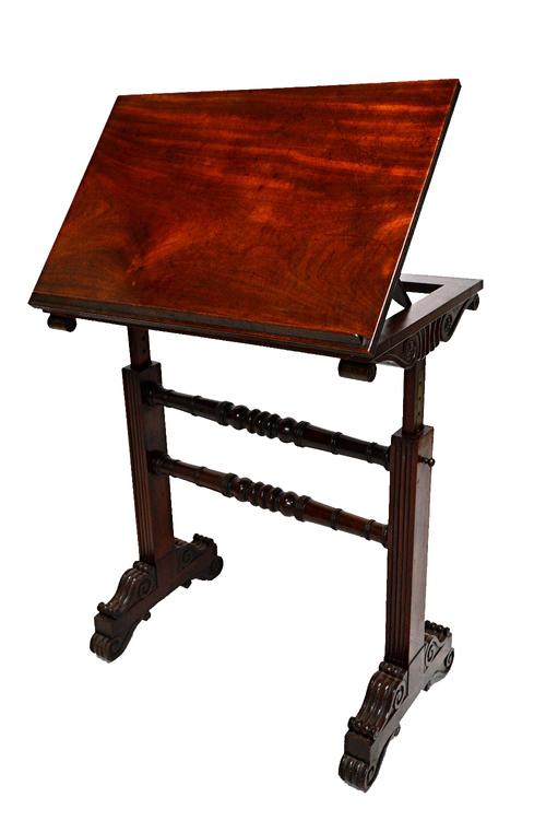 An early 19th century mahogany reading table, the rectangular height and angle adjustment top on a pair of trestle end standards, 68cm wide.  Illustra