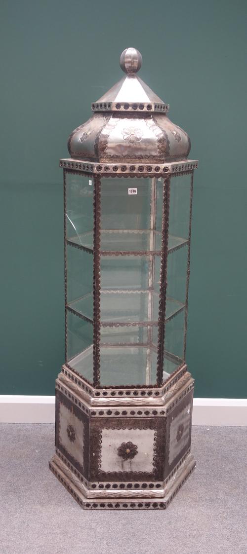 A 20th century Islamic design polished metal veneered free standing hexagonal display cabinet, on plinth base, 52cm wide x 180cm high.