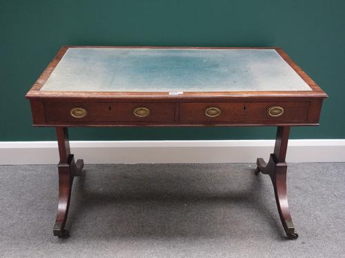 A 19th century writing table, the rectangular top with two frieze drawers on trestle end standards, on four downswept supports, 109cm wide.