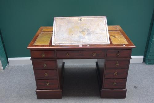 A 19th century mahogany pedestal desk, the top with angle adjustment surface, over nine drawers about the knee, 124cm wide.