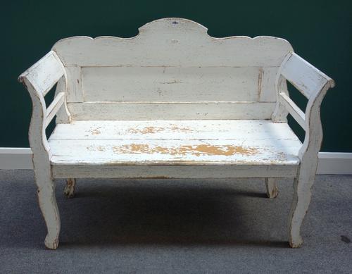 A 19th century North European white painted pine hall bench, with solid seat and shaped supports, 125cm wide.