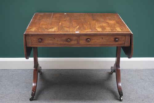 A George III yew wood banded rosewood sofa table, with a pair of frieze drawers and dummy verso, on trestle end standards and four downswept supports,