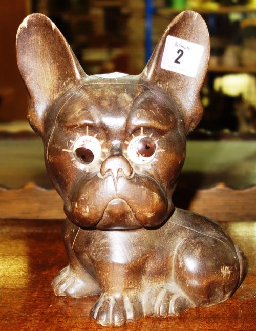 A 20th century clock formed as a small dog, with the hours and minutes displayed in the eyes, stamped Oswald Germany.