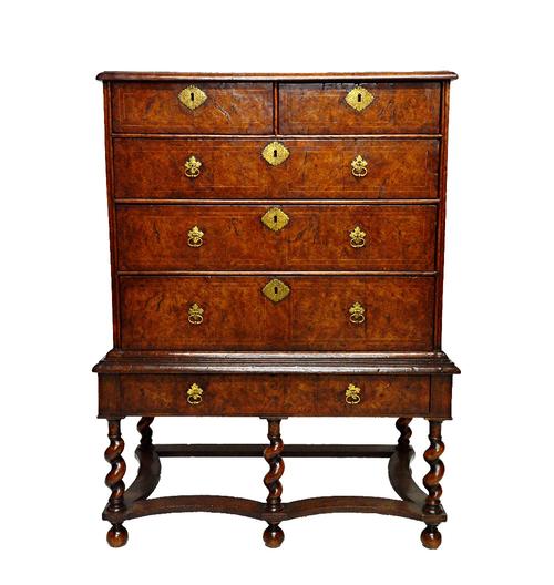 A William and Mary holly strung pollard oak chest on stand of two short over three long graduated drawers, the base with one long drawer on barley-twi