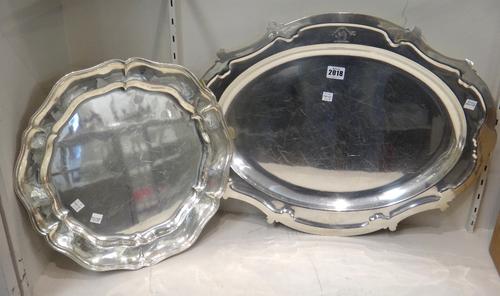 A plated shaped oval serving dish, crest and motto engraved, length 56cm and a plated shaped circular dish, with a Chippendale style border, diameter