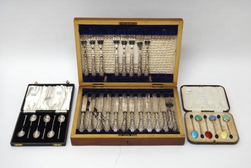 A part set of twelve dessert knives and eleven dessert forks, having plated blades and prongs and with loaded silver handles, with a wooden case, a se