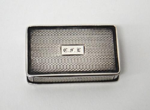 A William IV silver rectangular vinaigrette, the exterior with engine turned decoration, having a floral and scroll engraved and pierced grille, by Na