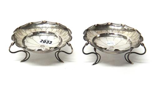 A pair of Chinese bonbon dishes, each formed as a flowerhead and raised on three wirework feet, having bud terminals, detailed WH 90, diameter 13cm, c