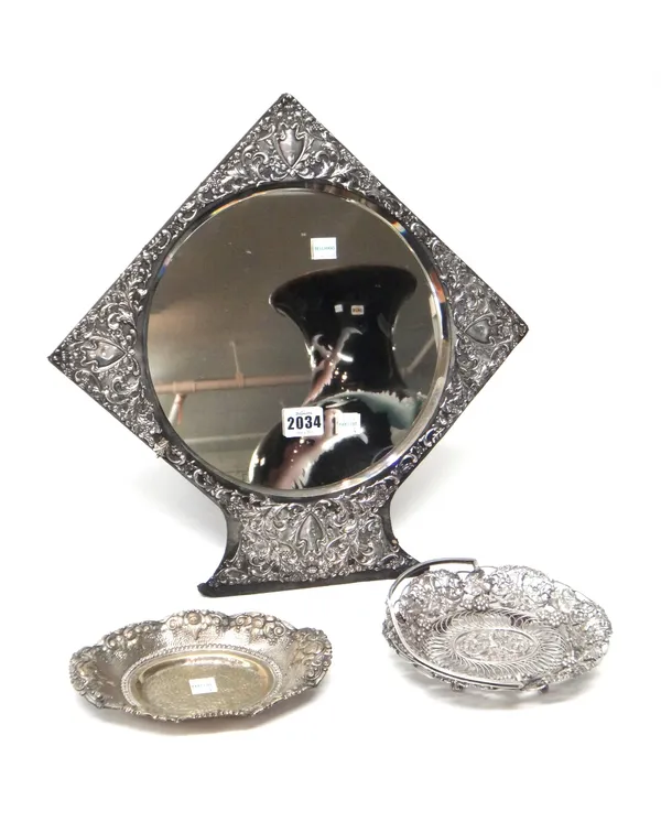A silver mounted circular mirror, having embossed decoration, Birmingham 1902, an oval bonbon dish, decorated with a floral border, detailed 800 and a