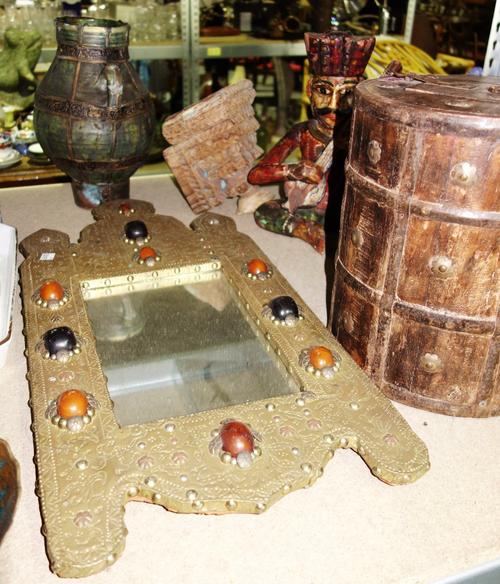 An Inidan hardwood cylindrical lidded pot and a carved and painted Indian figure, a brass mirror and a hardwood wall sconce.
