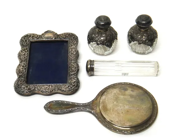Silver and silver mounted wares, comprising; a Victorian shaped rectangular photograph frame, having pierced and embossed decoration, Birmingham 1899,