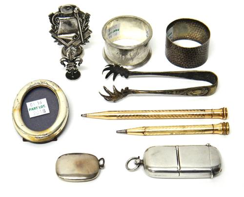 A silver sovereign case cum vesta case, Birmingham 1906, two silver napkin rings, a silver small pendant powder compact, Birmingham 1916, a silver mou
