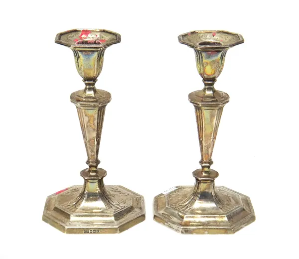 A pair of George V silver candlesticks, Sheffield 1916, on stepped rectangular cut corner loaded bases. (2)