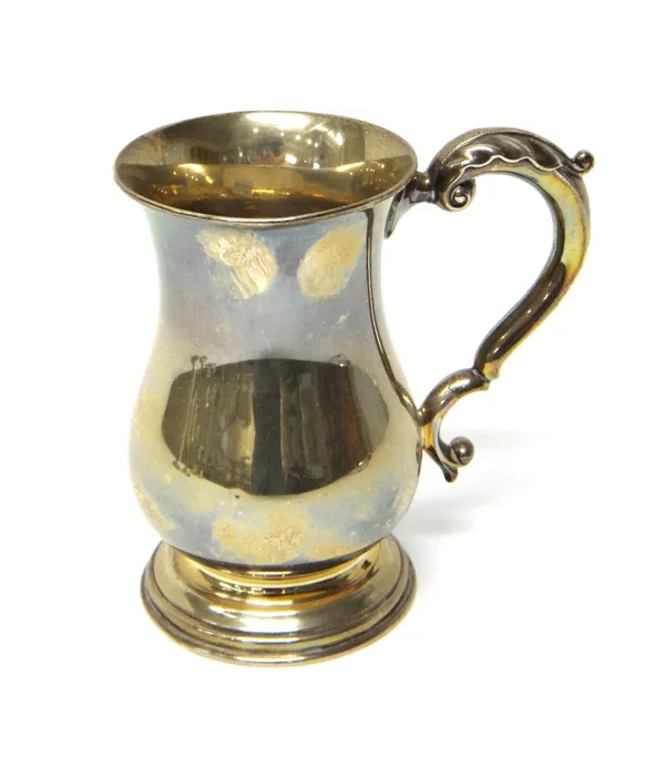 A George VI silver tankard of baluster form, Sheffield 1943, with acanthus capped scroll handle, on a spreading circular foot, the base detailed 'Dunh