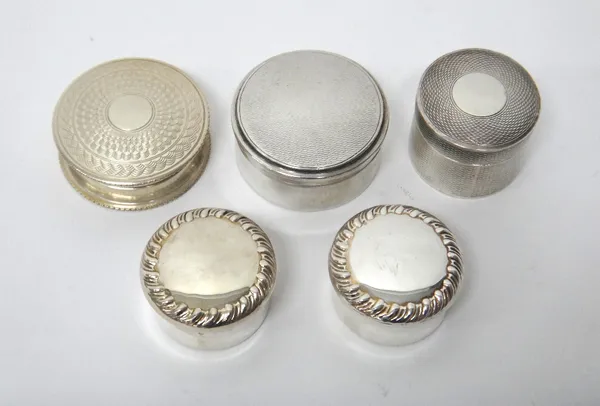 A pair of silver circular boxes, each decorated with a fluted rim, Birmingham 1910, a silver circular box, having engine turned decoration, Birmingham
