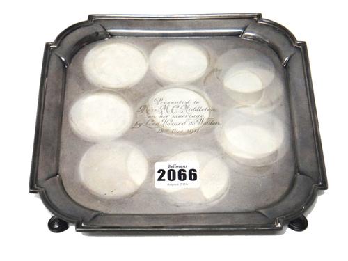 A silver salver, of shaped square form, in the early 18th century taste, raised on four pad feet, the centre presentation inscribed, 20cm square, weig