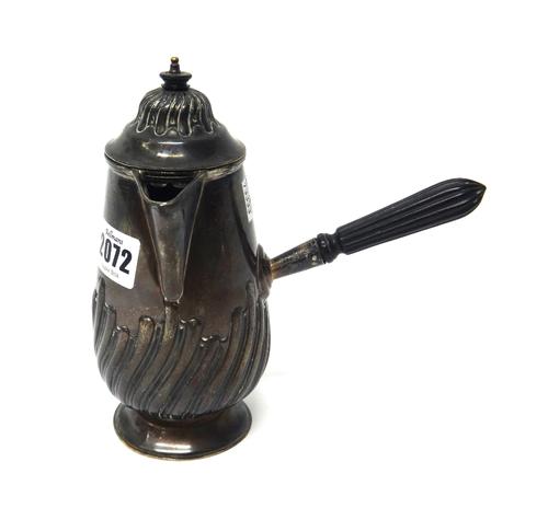 A Victorian silver hot milk jug, of tapered baluster form, having partly spiral fluted decoration and with a wooden handle and finial, Birmingham 1896
