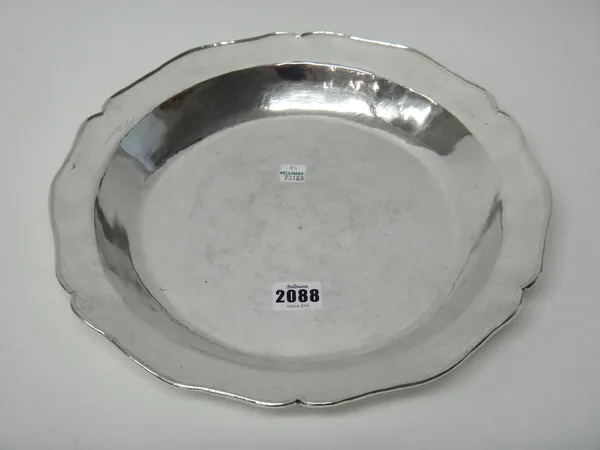 A South American shaped circular shallow basin, the underside of the rim monogram engraved, probably Peruvian mid 18th century, the bottom engraved wi