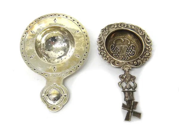 A George VI Liberty & Co silver tea strainer, Birminghamd 1939, decorated with Celtic motifs, and a Dutch silver tea strainer with foliate and scroll
