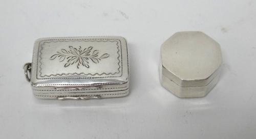 A George III silver octagonal vinaigrette, the exterior plain, by Samuel Pemberton, Birmingham 1798 and a silver rectangular vinaigrette, with a pierc