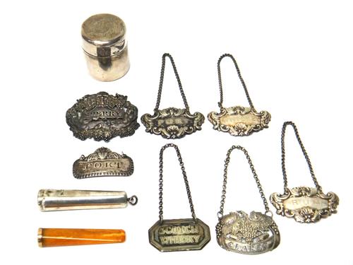Two George III silver decanter labels, five further plated decanter labels, a silver tapered cylindrical cheroot case fitted with a cheroot holder and