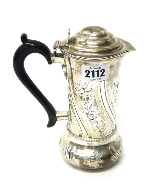 A Victorian silver hot water jug, decorated with floral and fluted bands, with a replacement ebonised handle and having a weighted base, London 1890.