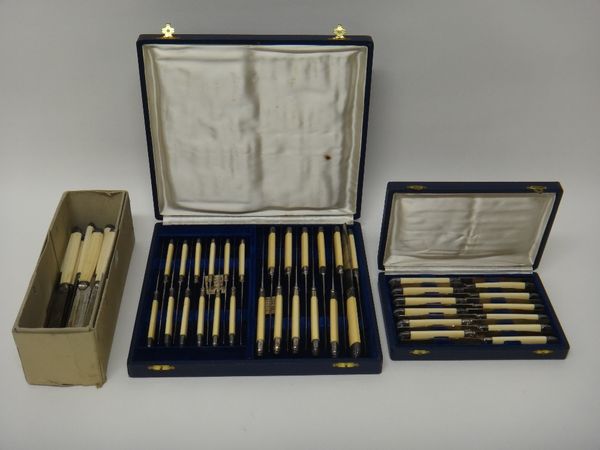 A set of twelve French silver bladed fruit knives with ivory handles, cased, another cased set of twenty four knives with ivory handles, and eighteen