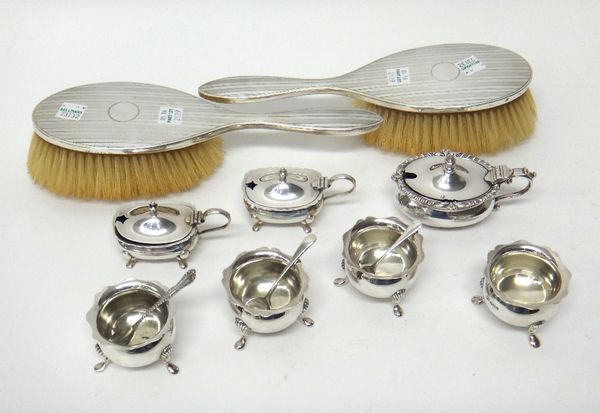 Silver and silver mounted wares, comprising; a set of four shaped circular salts, each raised on three feet, Sheffield 1899, the liners lacking, a pai