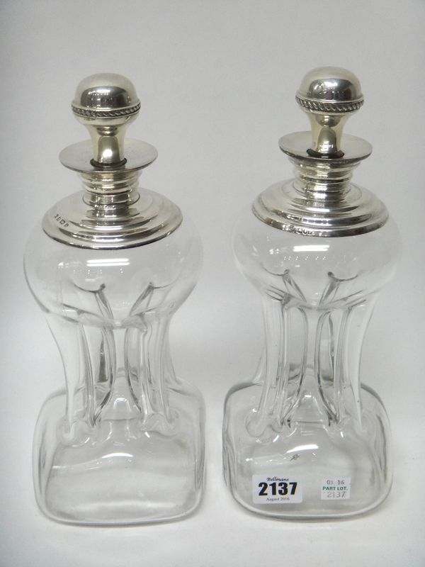 Two similar silver mounted dimple shaped glass decanters and stoppers, Birmingham 1901 and London 1902.