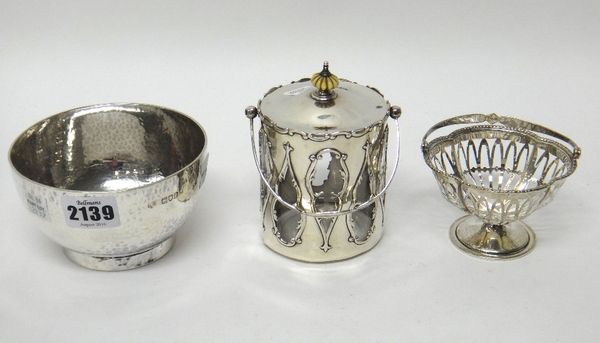 Silver, comprising; a late Victorian circular sugar bowl, having a beaten finish, by Carrington & Co, London 1900, a bonbon basket of quatrefoil shape