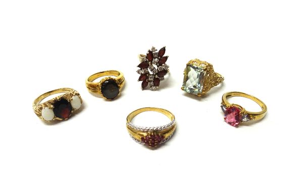 A 9ct gold and ruby set lozenge shaped cluster ring, mounted with nine circular cut rubies, within cable sides, a 9ct gold, garnet and colourless gem