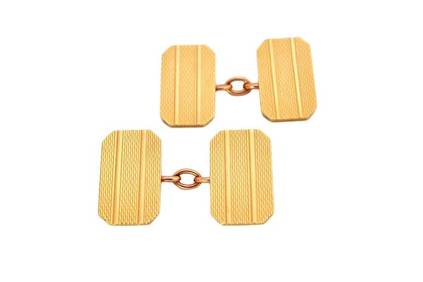 A pair of 9ct gold cut cornered rectangular cufflinks, with engine turned decoration, London 1962, combined weight 10 gms, with a case.  Illustrated