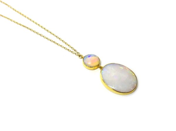 An opal pendant necklace, yellow metal mounted with a circular opal and an oval opal, on an integral neckchain.