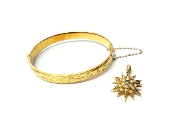 A gold, demantoid garnet and seed pearl set pendant brooch, designed as a starburst, detailed 18 and a gold oval hinged bangle, the front with scroll